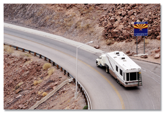 An RV driving down a winding hill