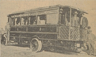 A 1910 Pullman bus with people inside